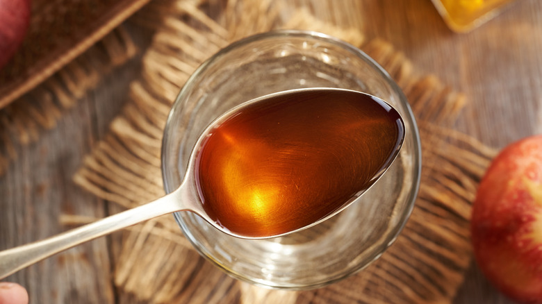 Close up of spoonful of apple cider vinegar