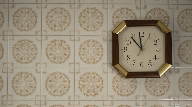 A simply vintage clock on a boring backsplash