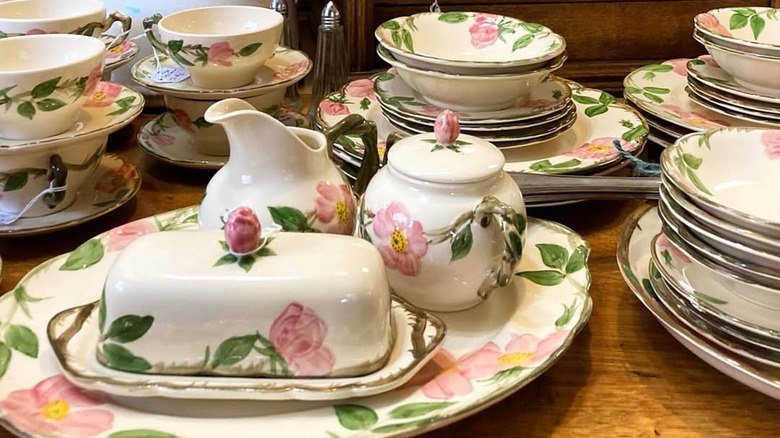 A collection of Franciscan dinnerware in the pattern Desert Rose composed of green lead and pink flower enamels.