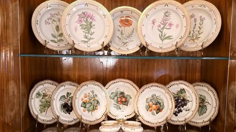 A collection of Royal Copenhagen Flora Danica plates with beautiful flower motifs.