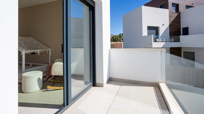 An open sliding glass door in a stylish apartment