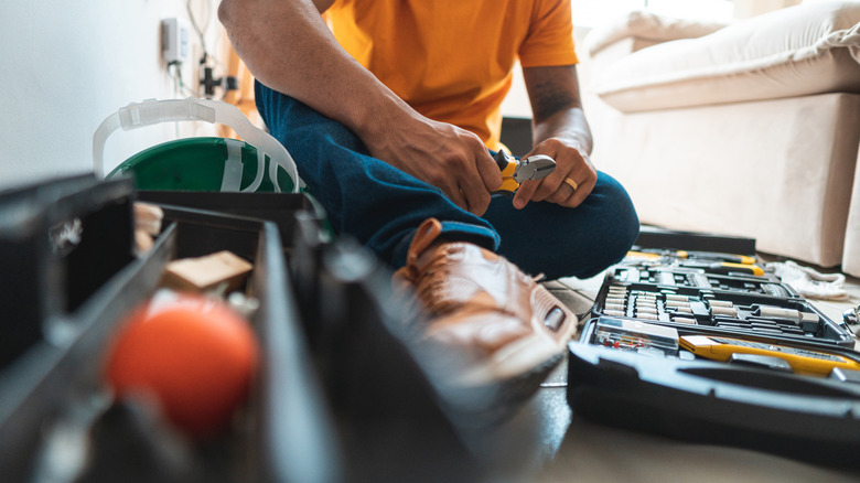 Sitting on floor with tools