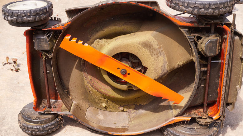 A lawn mower deck and blades ready for a protective coating