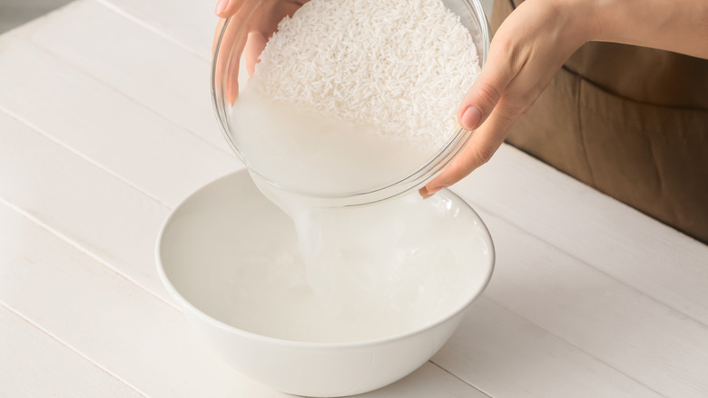 Pouring rice water into bowl