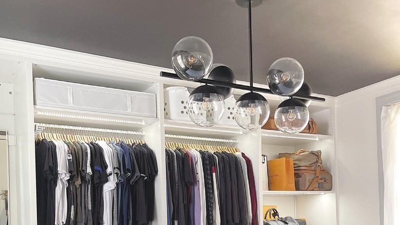 Linear statement pendant light hanging in a closet