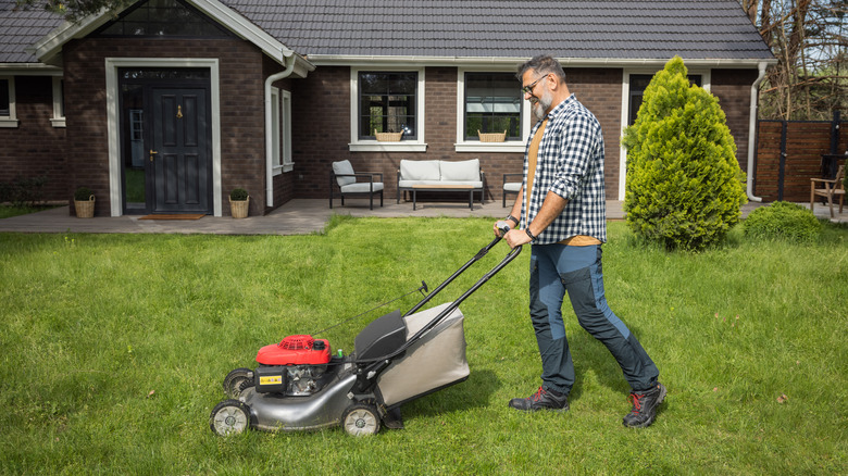 man pushing a lawn mower