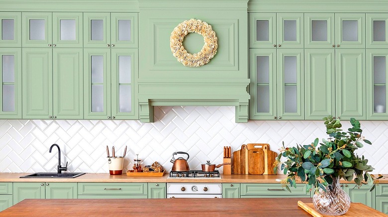 Green kitchen with white tile