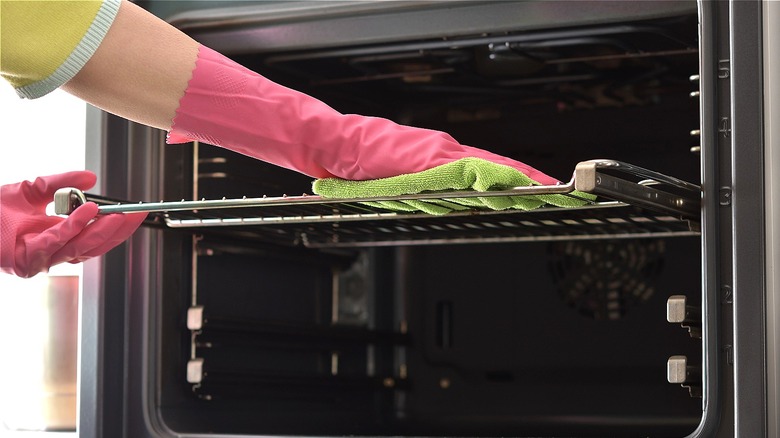 Person cleaning oven rack