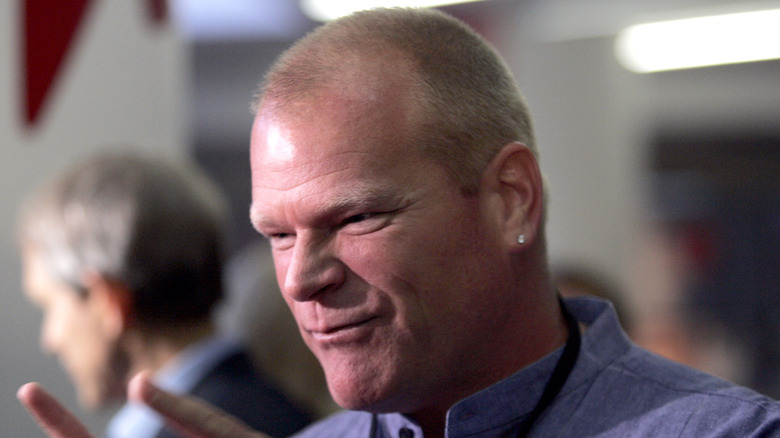 Mike Holmes is photographed while engaged with someone off camera.