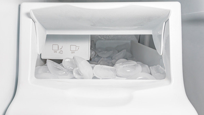 white ice maker in fridge