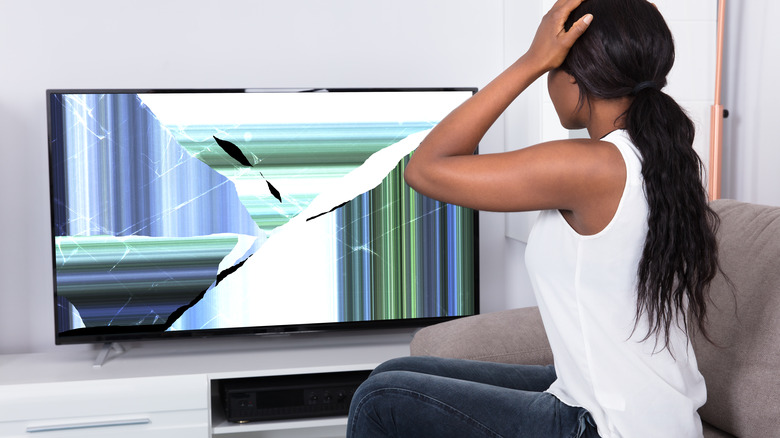 Frustrated woman cracked TV screen