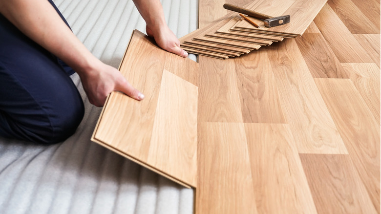 person repairing flooring