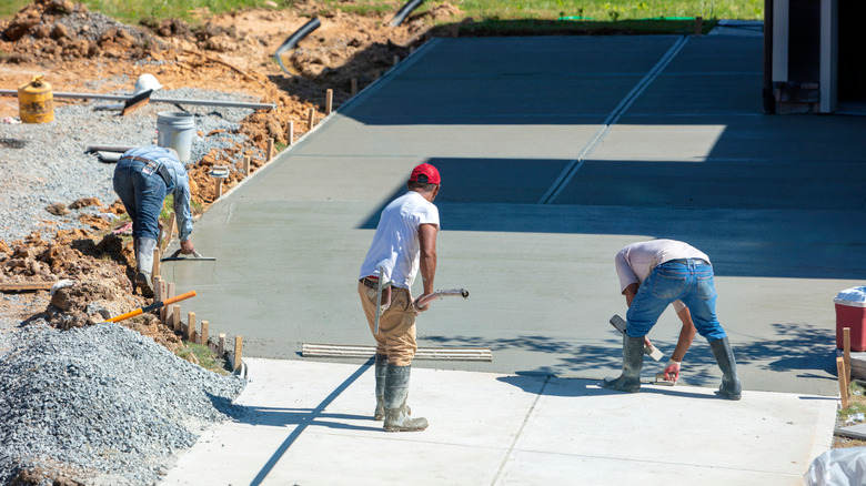 Men replacing concrete driveway