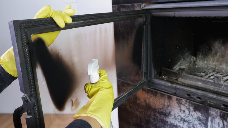 person cleaning a fireplace