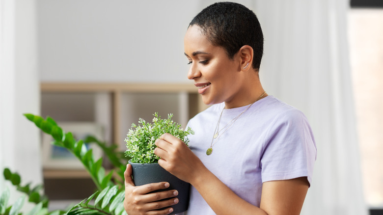 woman holding houseplant