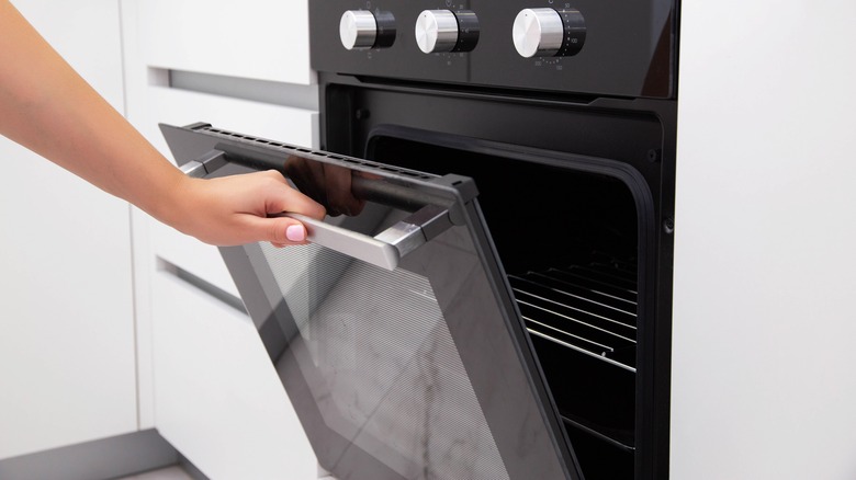 Woman opening oven
