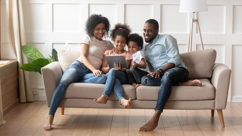 family sitting on sofa