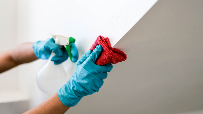 Person cleaning wall 