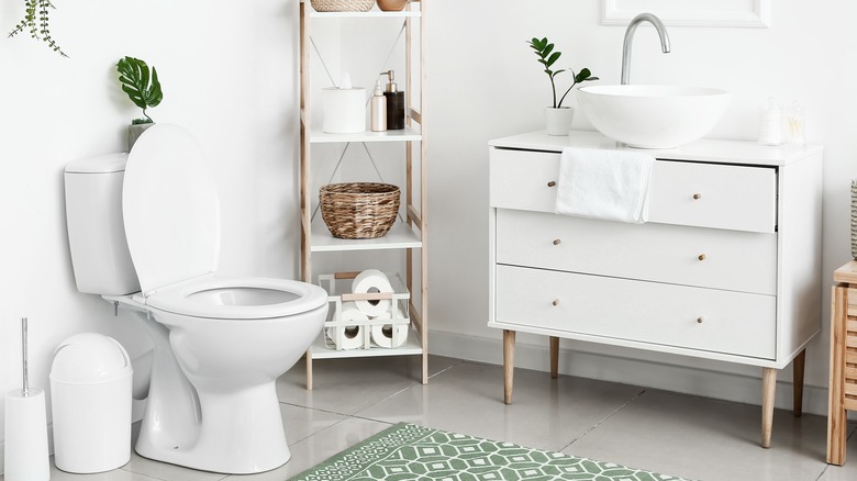 Toilet and sink in white bathroom