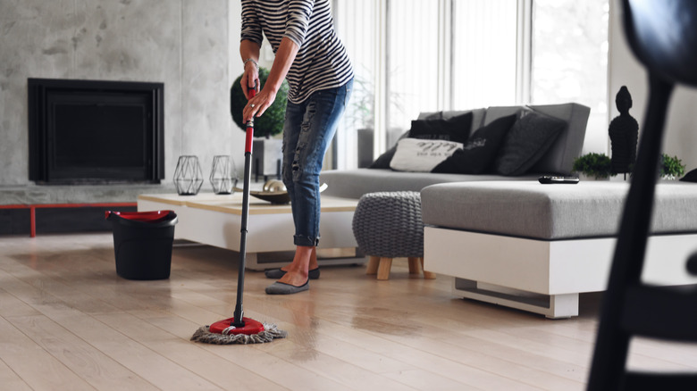 Woman mopping living room floors
