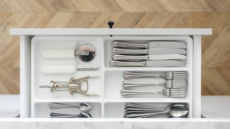 Cutlery drawer with silverwareWhat's one thing you use almost daily but rarely think to clean? How about that tray helping to keep silverware drawer organized? We go in and out of those trays often removing and replacing clean eating utensils but cleaning them frequently isn't usually on the radar. How often should you be taking care of that task? Once a month is a good target, according to cleaning specialists Glanz Berlin.   Silverware organizers can be made of plastic, wood, or metal mesh. There are even rattan versions that look good enough to pull out of the drawer to use for entertaining. Some expand to fit the size of your drawer while others are one-size-fits-all units. No matter which one you've selected for your kitchen, plan to clean it at least once a month. 