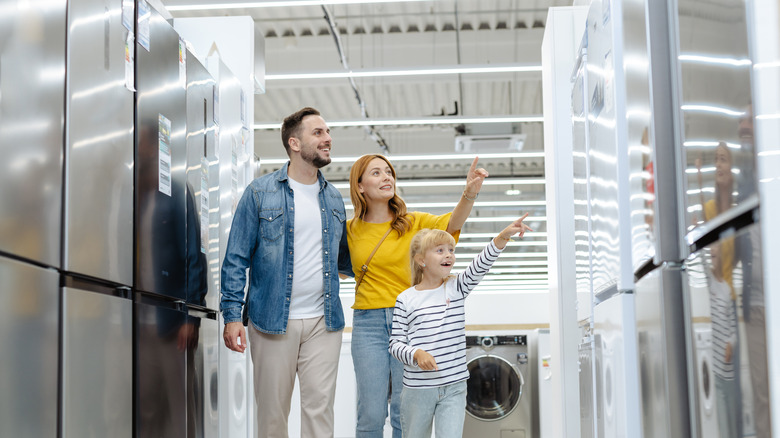 A family looking at fridges in an appliance store