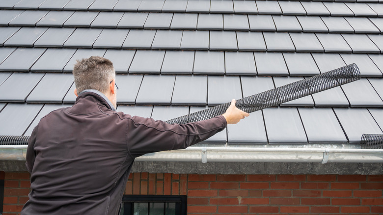 man installing gutters