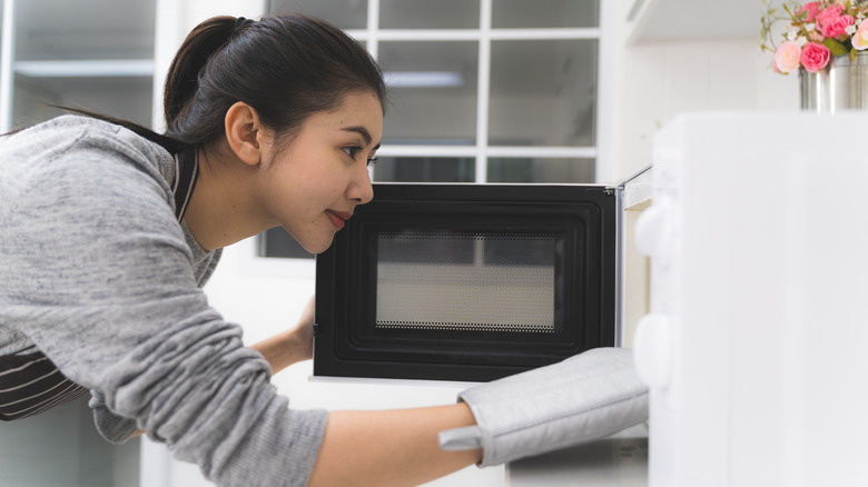 woman using microwave