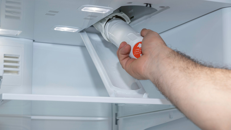 Person installing water filter