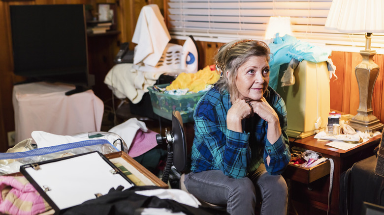 Woman in a cluttered room