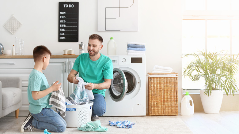 Father and son doing laundry