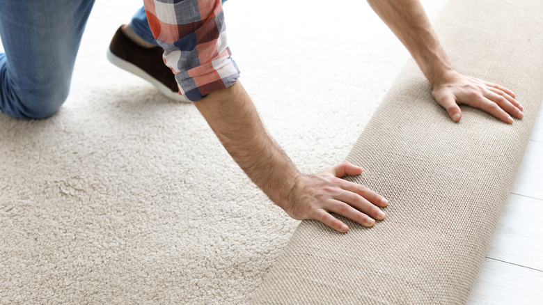 Person installing carpet