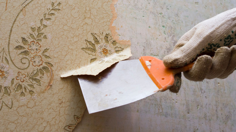 hand removing wallpaper