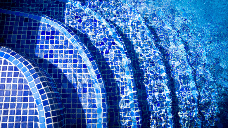 blue tiled stairs in pool