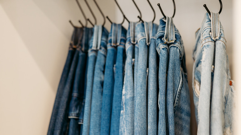 Jeans hanging on hooks
