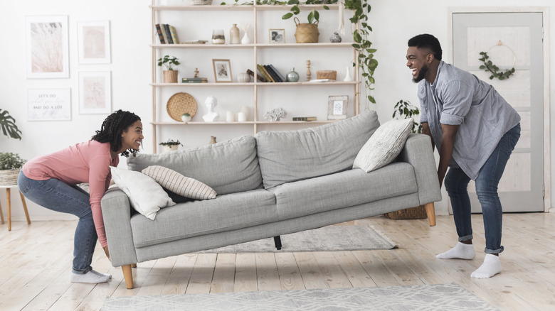 Couple lifting couch