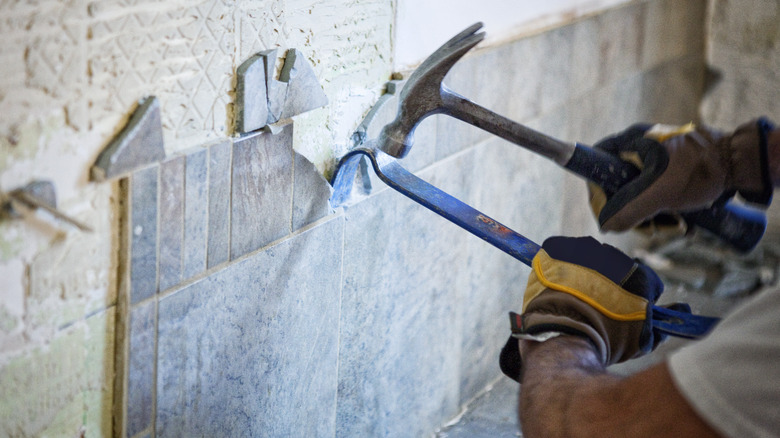 person removing tile 