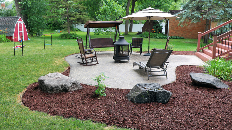 Patio surrounded by green lawn
