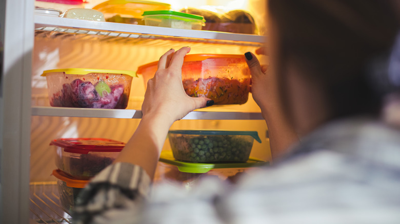 Someone organizing fridge