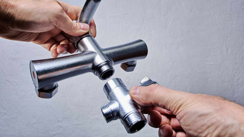 Person holding a mixer shower valve