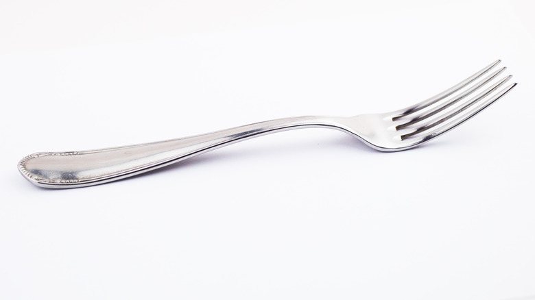 Silver fork on white background