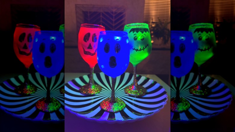 Three pumpkin-faced wine glass lights