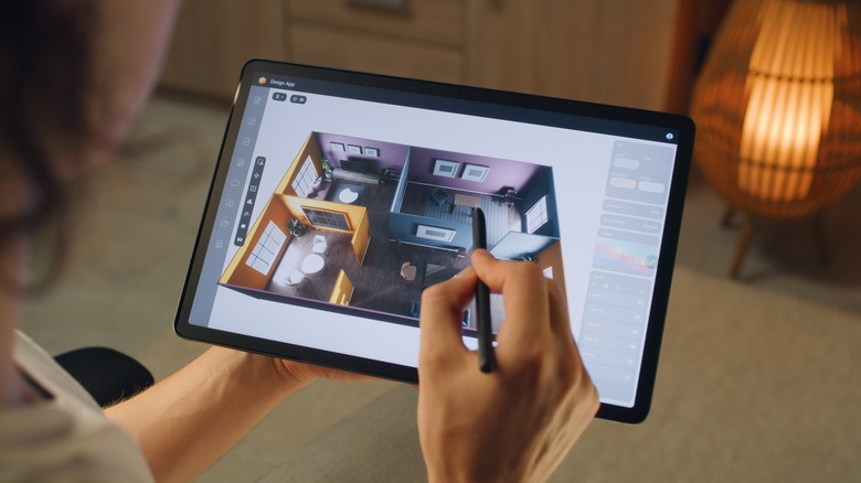 woman designing home via tablet