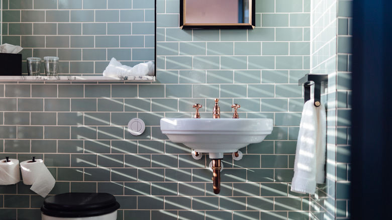 Green subway tile bathroom with eclectic fixtures