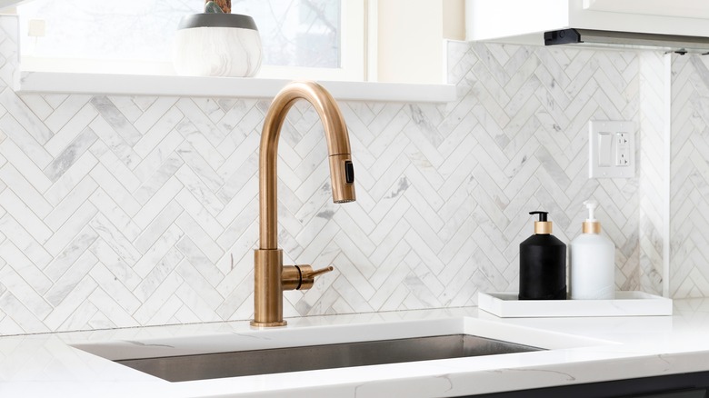 kitchen faucet against backsplash