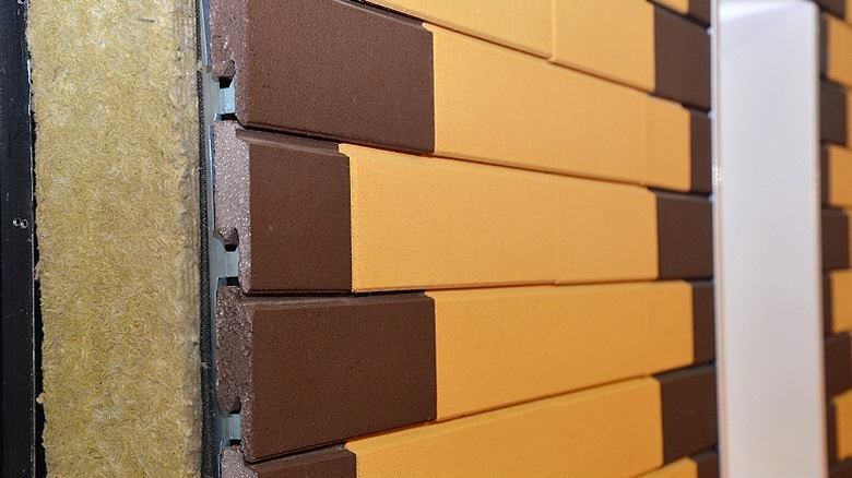 A rainscreen is displayed on the side of a house