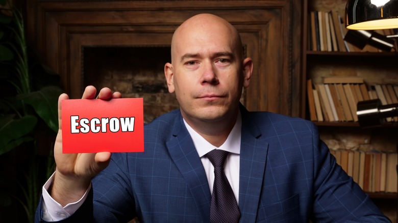 man holding escrow card