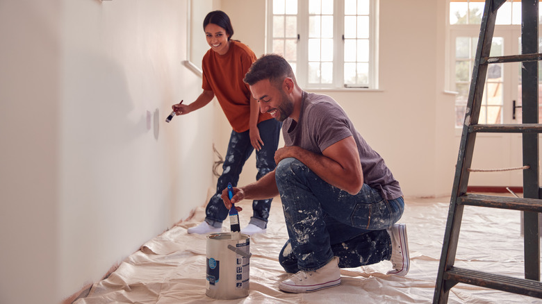 Couple painting walls