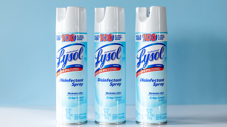 three bottles of lysol spray