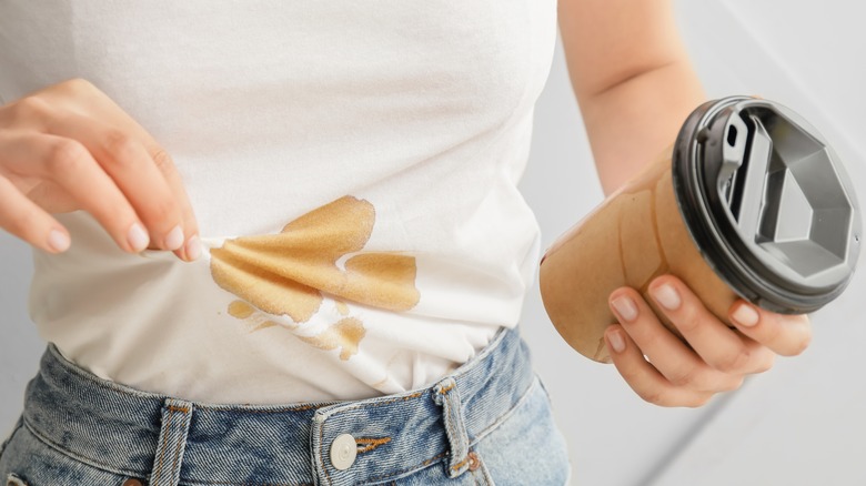 person with white coffee-stained shirt